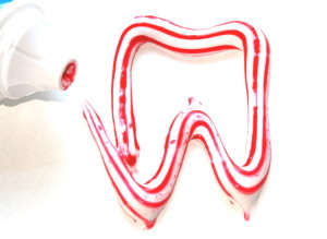 Zahnpasta als Zahn und Tube